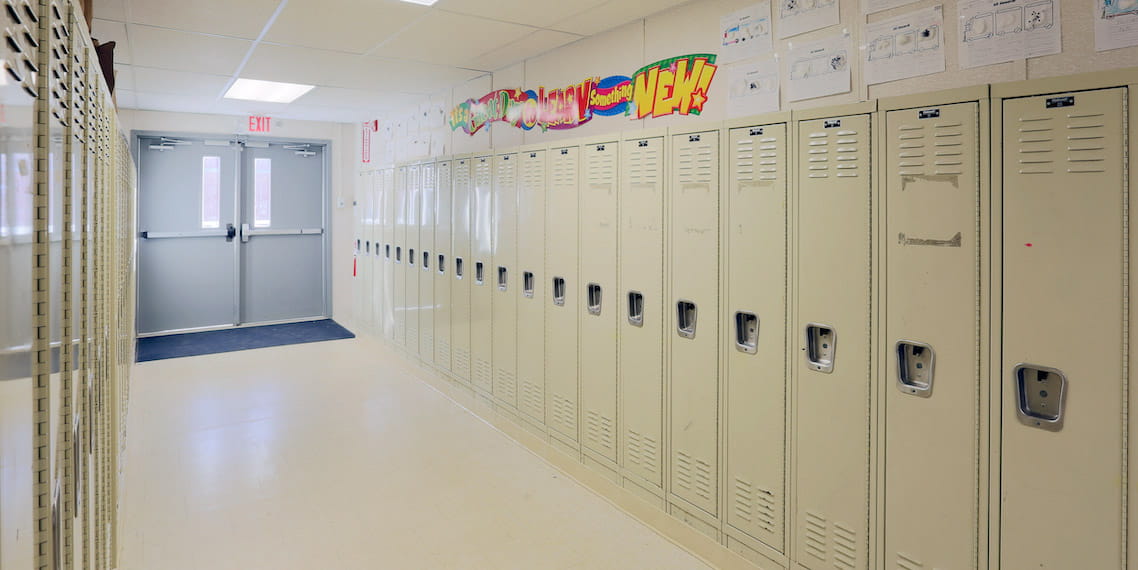 An empty school hallway lined with lockers