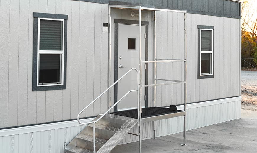 Premium entrance package with canopy and handrail outside of a mobile office trailer